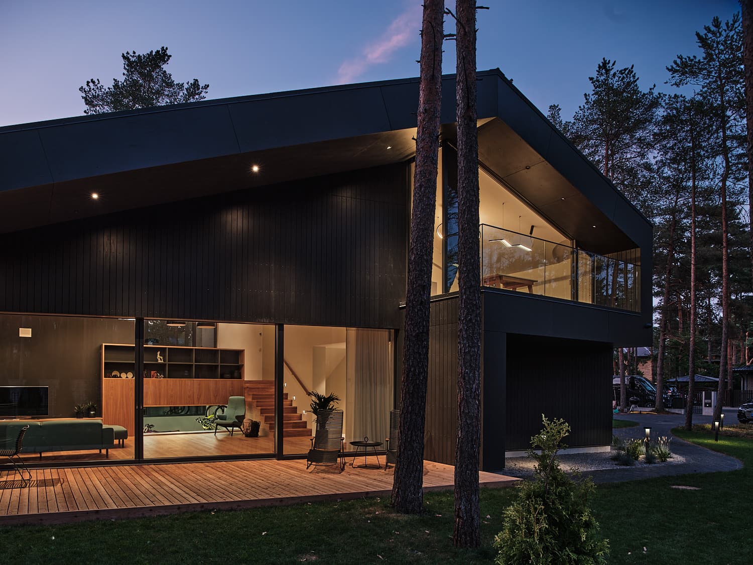 Modern house with large Smartwin timber-aluminium passive house windows at dusk