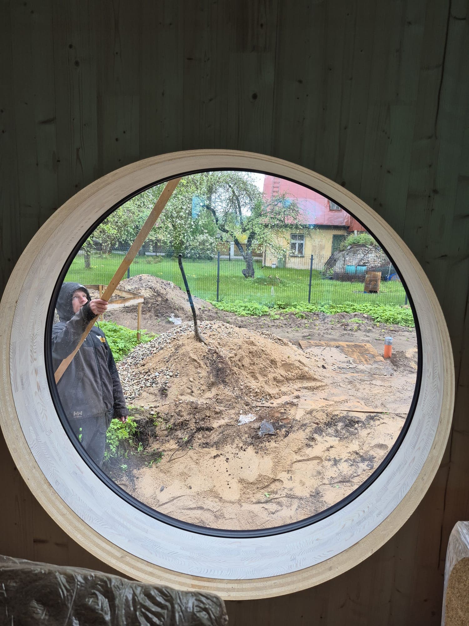 Close-up of O360 round window from interior during construction